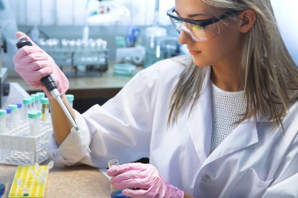 Girl in a labratory, pipetting