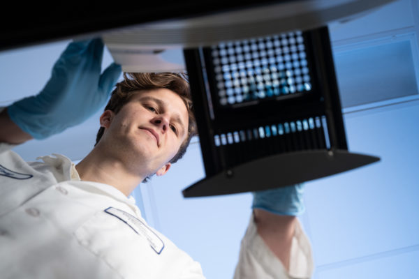 Person working in lab with gloves